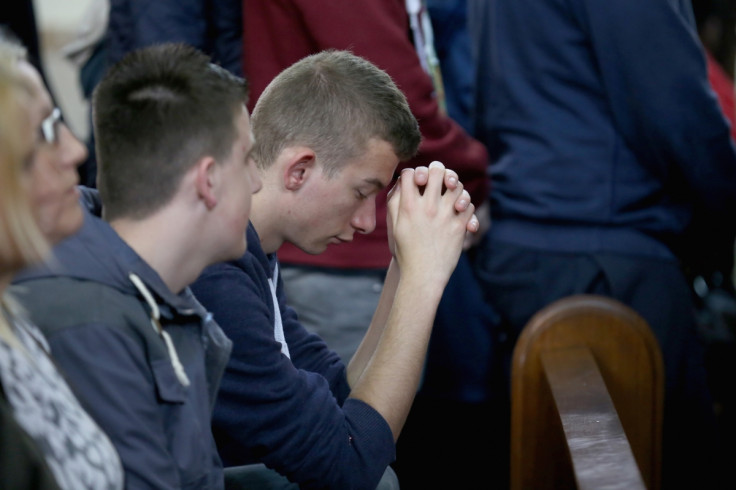 Students attend Corpus Christ Catholic Church in memory of Anne Maguire, who was stabbed to death in the school next door