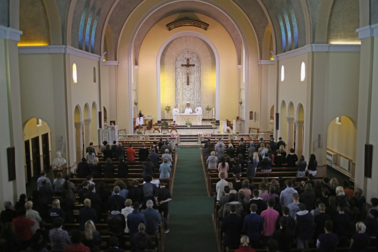 Monsignor Paul Fisher conducts mass at Corpus Christ Catholic after teacher Anne Maguire was stabbed to death in the school next door