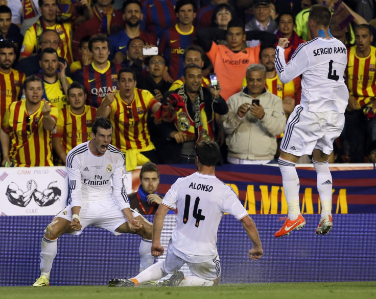 Real Madrid's Gareth Bale celebrates his goal with teammates Xabi Alonso (C) and Sergio Ramos (R) during their King's Cup final soccer match against Barcelona at Mestalla stadium in Valencia April 16, 2014.