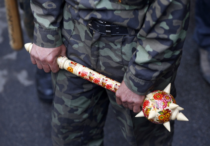 A pro-Russian activist holds a mace outside the regional government headquarters in Luhansk, eastern Ukraine