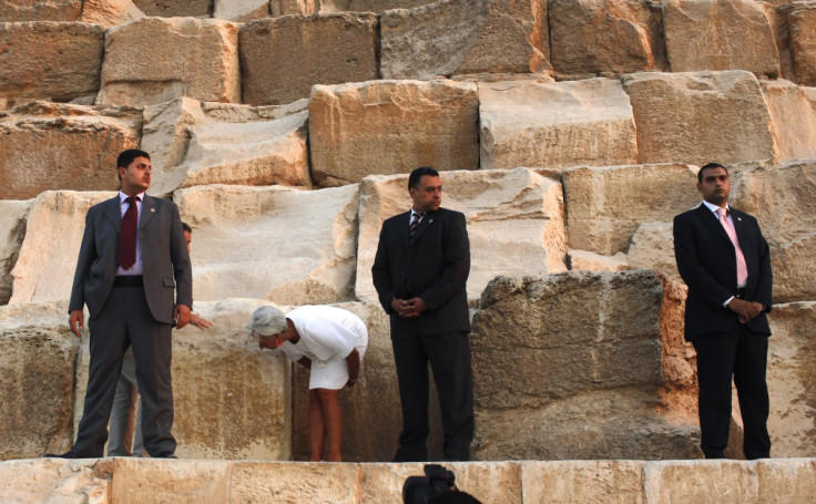 International Monetary Fund (IMF) Managing Director Christine Lagarde (2nd L) checks some pyramid stones next to security guards