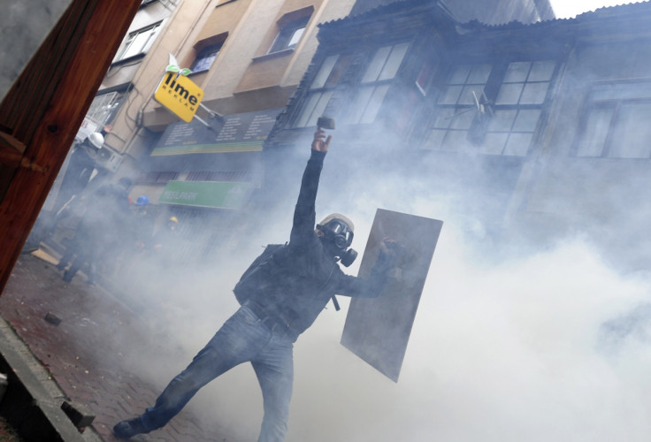 A protester throws stone at riot police during a May Day demonstration in Istanbul