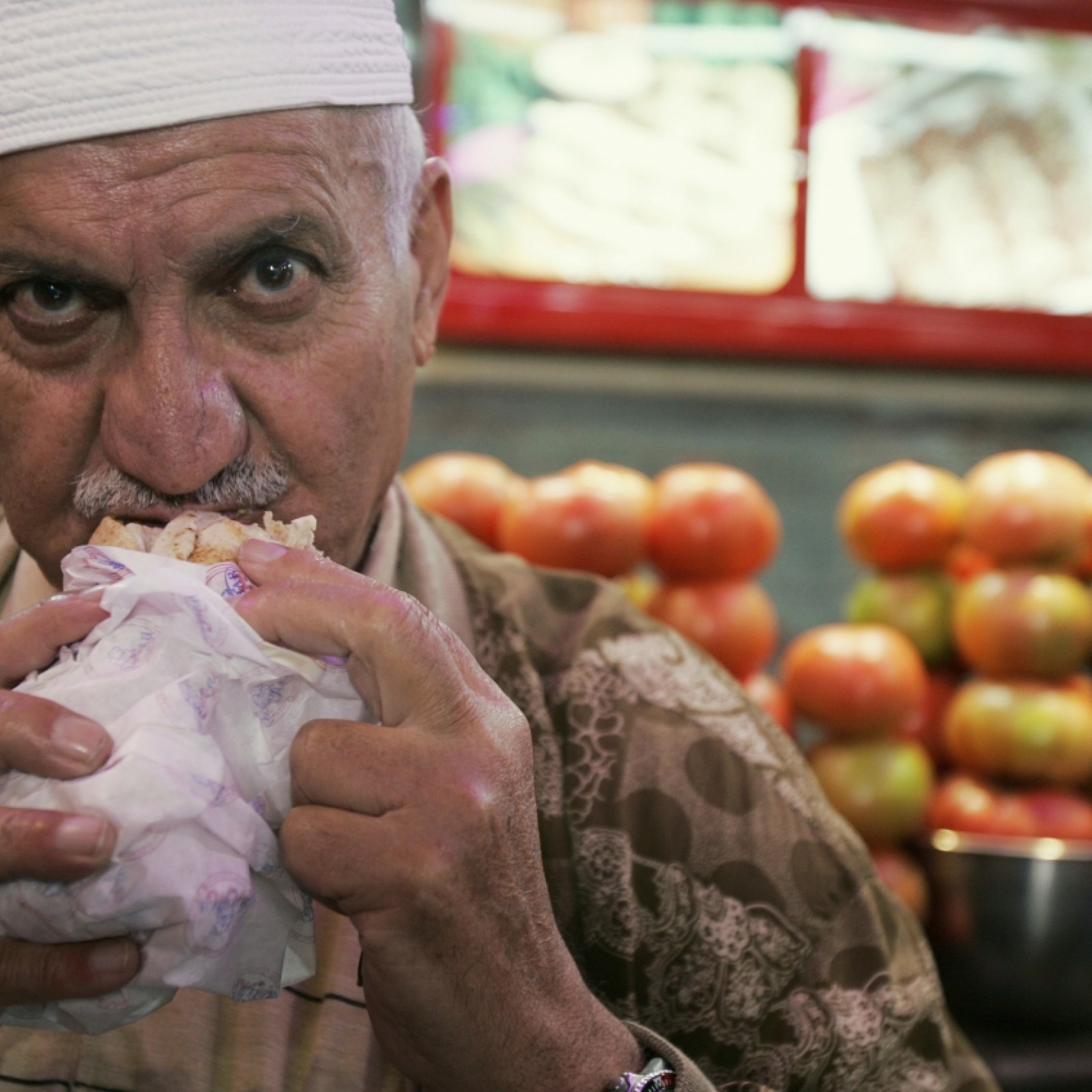 A Lebanese man eats a falafel sandwich at a restaurant in Beirut