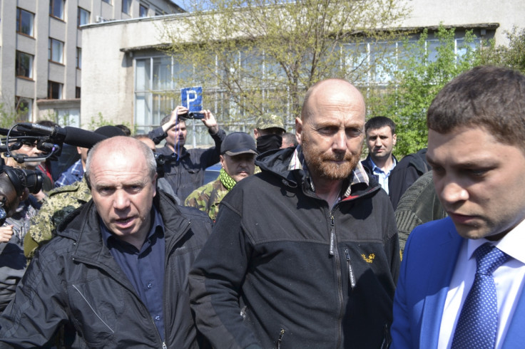 OSCE observer Axel Schneider (C) is escorted after being freed by pro-Russian separatists in the town of Slaviansk in eastern Ukraine