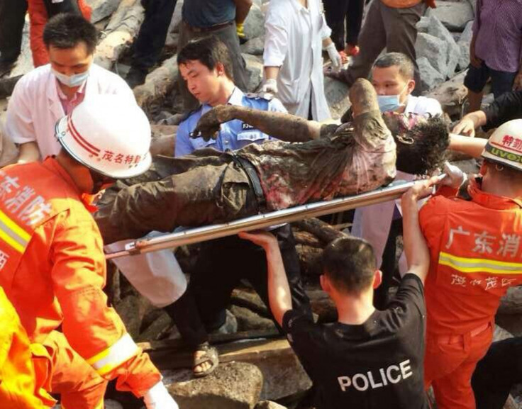 Rescue workers carry an injured man after a bridge collapsed during construction in Maoming, Guangdong province