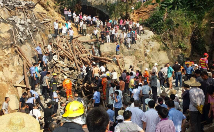 Rescue workers at the scene of the fatal bridge collapse in China