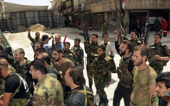 Forces loyal to Syria's President Bashar al-Assad cheer upon the release of their comrades by rebels in Aleppo's Bustan al-Qasr Forces loyal to Syria's President Bashar al-Assad cheer upon the release of their comrades by rebels in Aleppo's Bustan al-Qasr
