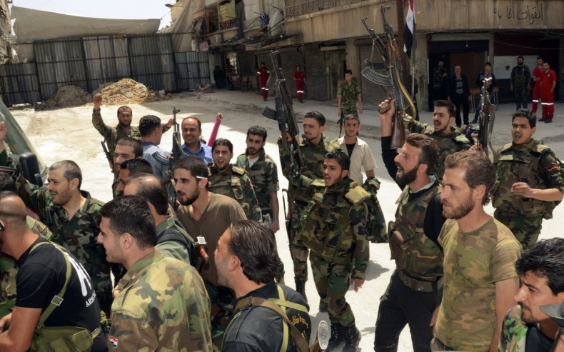 Forces loyal to Syria's President Bashar al-Assad cheer upon the release of their comrades by rebels in Aleppo's Bustan al-Qasr