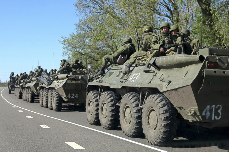 Russian servicemen drive armoured personnel carriers on the outskirts of the city of Belgorod near the Russian-Ukrainian border