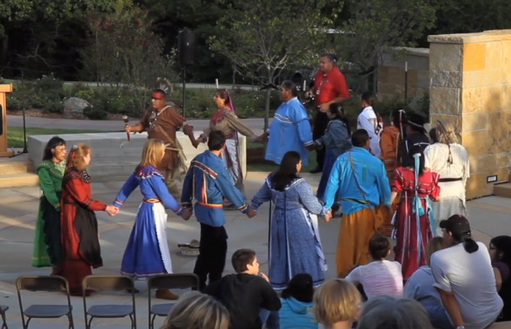 Chickasaw tribe members performing a stomp dance at the Chickasaw Cultural Center