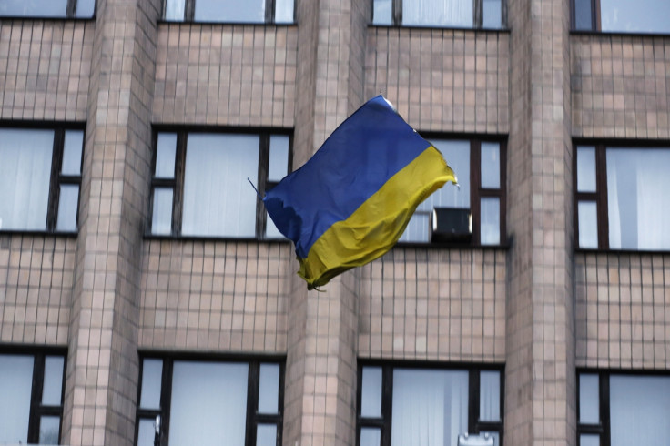A Ukranian flag falls after it was thrown by pro-Russia protesters from the top of the district council building in Donetsk, eastern Ukraine