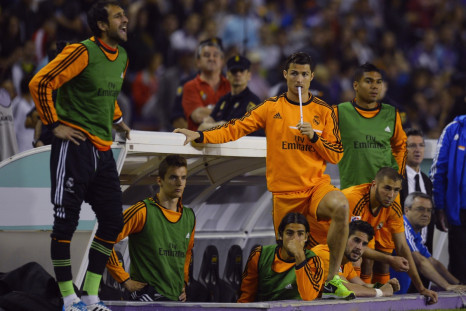 Real Madrid's Cristiano Ronaldo (C) and teammates watch their Spanish First Division soccer match against Valladolid from the bench, at Zorrilla Stadium in Valladolid May 7, 2014.