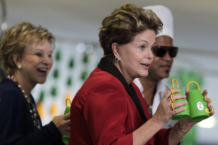 Brazil's President Dilma Rousseff holds the Caxirola, musical instrument to be used at the 2014 Brazil World Cup