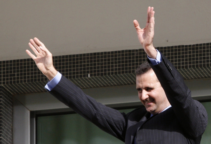 Bashar al-Assad waves to suporters from the balcony of the presidential palace in Damascus.