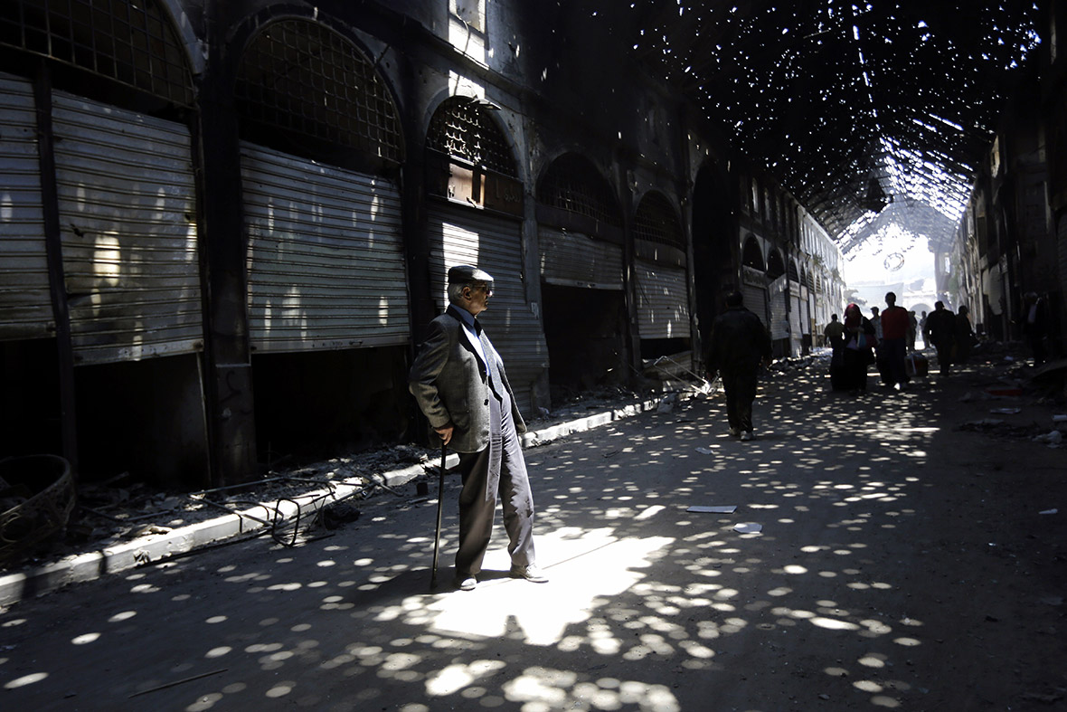 Rays of light burst through holes in the roof of Maskuf covered market, or Souk,  in the Old City of Homs