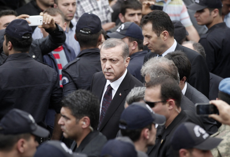 Turkey's Prime Minister Tayyip Erdogan (C) walks during his visit to Soma, a district in Turkey's western province of Manisa, after a coal mine explosion