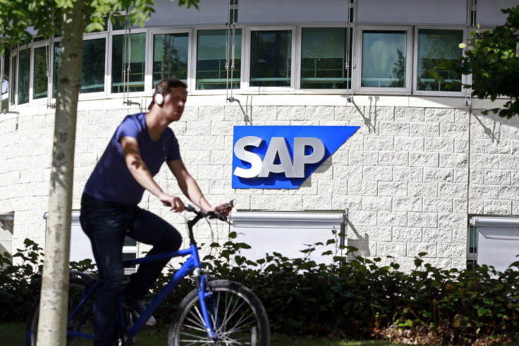 A man cycles past the SAP logo at its offices in the CityWest complex, Dublin