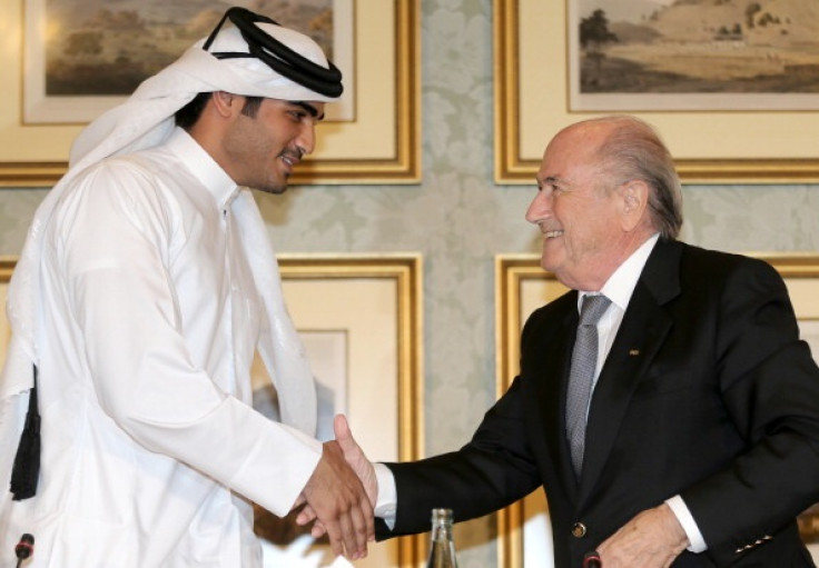 Sheikh Mohammed bin Hamad al-Thani (L) shakes hands with FIFA president Sepp Blatter