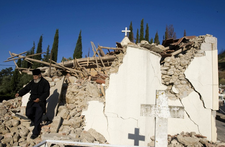 An Orthodox priest walks on the debris of a church of Valmi village, south-west of Athens.