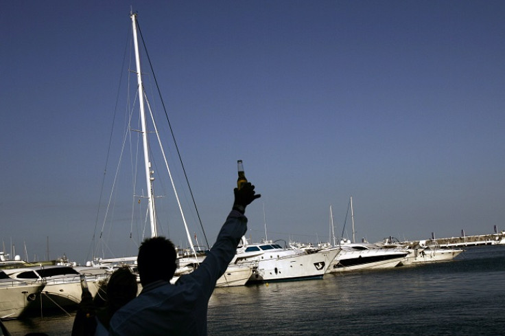 Tourists drink beer at the popular holiday resort of Puerto Banus on the Costa del Sol in southern Spain.