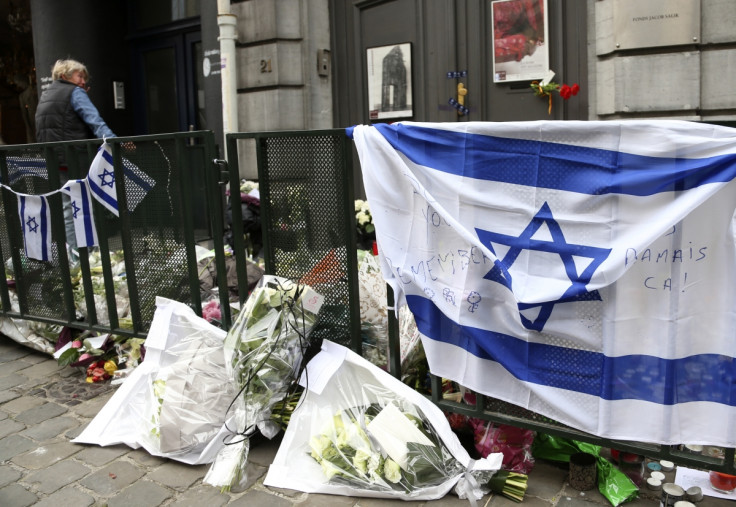 A woman stands at the entrance of the closed Jewish Museum in Brussels
