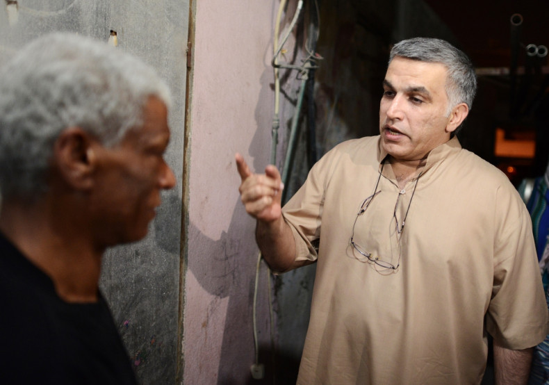 Activist Nabeel Rajab (R) speaks to his neighbour after his release from jail, in the village of Bani Jamra, west of Manama