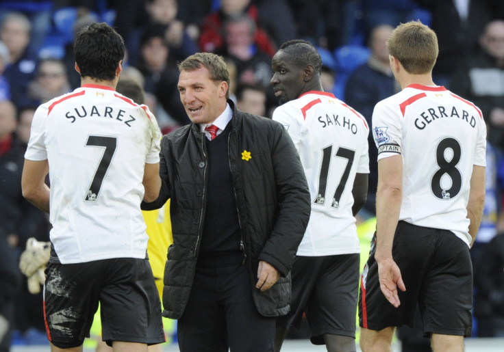 Liverpool's manager Brendan Rodgers (C) congratulates Luis Suarez after scoring a hat trick against Cardiff City during their English Premier League soccer match at Cardiff City Stadium in Cardiff, Wales, March 22, 2014.