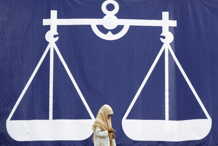 A Muslim girl walks past a giant display of Malaysia's ruling National Front coalition in the village of Kampung Tiung, in the opposition stronghold state of Kelantan March 6, 2008.