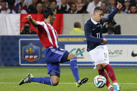 France's Antoine Griezmann (R) challenges Paraguay's Victor Caceres during their international friendly soccer match at the Allianz Riviera soccer stadium in Nice, June 1, 2014.