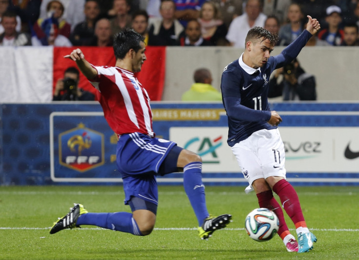France's Antoine Griezmann (R) challenges Paraguay's Victor Caceres during their international friendly soccer match at the Allianz Riviera soccer stadium in Nice, June 1, 2014.