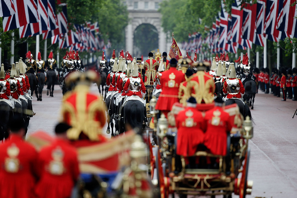 A military procession escorts the carriage of Queen Elizabeth II as it processes down the Mall
