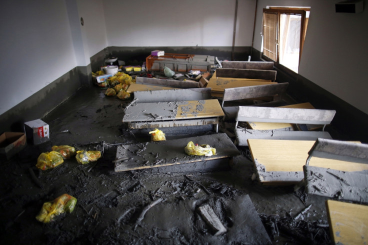 Mud covers a classroom and benches of a school in the aftermath of floods in Topcic Polje