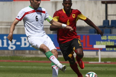 Iran's Javad Nekounam (L) challenges Angola's Joaquim Adao during a friendly soccer match in Hartberg May 30, 2014.