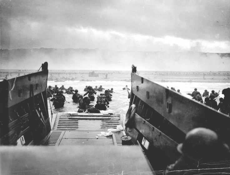US troops wade ashore from a Coast Guard landing craft at Omaha Beach during the Normandy D-Day landings near Vierville sur Mer, France, on June 6, 1944