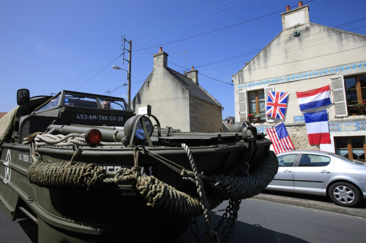 Dave Roe, a British military vehicle collector drives his "duck", a vintage U.S. WWII amphibious vehicle during a re-enactment of D-Day landings in Arromanches, on the Normandy coast