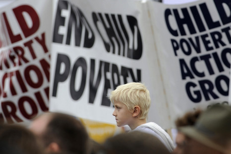 Demonstrators listen to speakers at a child poverty rally in Trafalgar Square, London