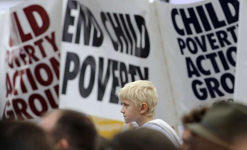 Demonstrators listen to speakers at a child poverty rally in Trafalgar Square, London