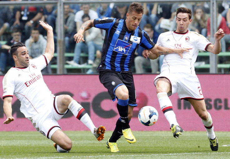 AC Milan's Adil Rami (L) and Mattia De Sciglio (R) fights for the ball with Atalanta's German Gustavo Denis during their Italian Serie A soccer match at Atleti Azzurri d'Italia stadium in Bergamo May 11, 2014.