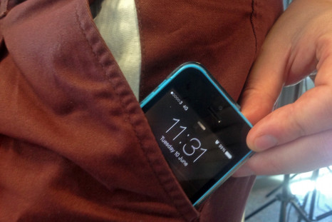An iPhone 5C smartphone in a pocket
