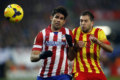 Atletico Madrid's Diego Costa (L) and Barcelona's Jordi Alba fight for the ball during their Spanish first division soccer match at Vicente Calderon stadium in Madrid January 11, 2014.