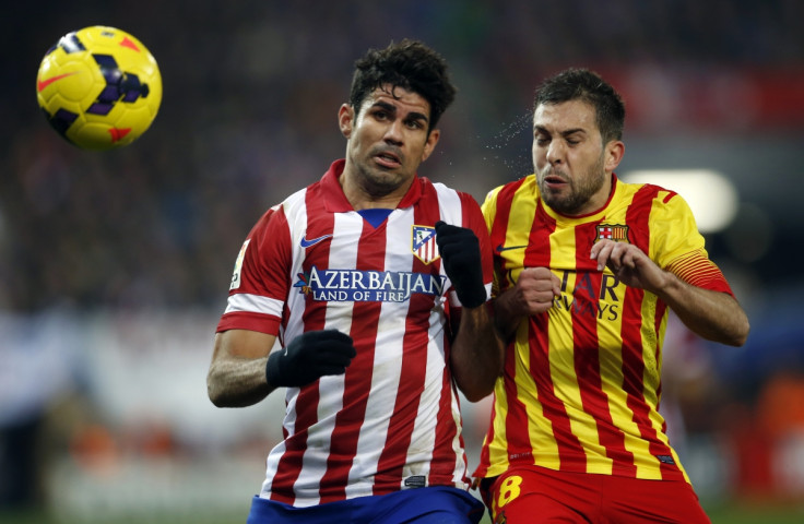 Atletico Madrid's Diego Costa (L) and Barcelona's Jordi Alba fight for the ball during their Spanish first division soccer match at Vicente Calderon stadium in Madrid January 11, 2014.
