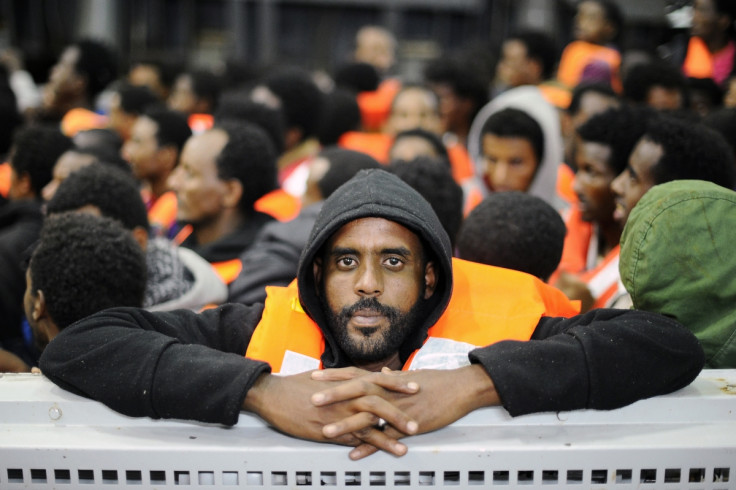 Migrants from Sub-Saharian areas stand on a rescue boat of Italy's Navy ship San Giorgio after being rescued in open international waters in the Mediterranean Sea between the Italian and the Libyan coasts