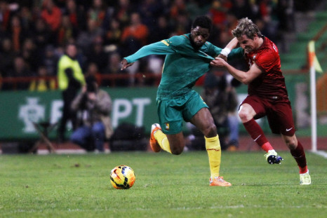 Portugal's Fabio Coentrao (R) fights for the ball with the Cameroon's Alex Song during their international friendly soccer match at Leiria stadium March 5, 2014.