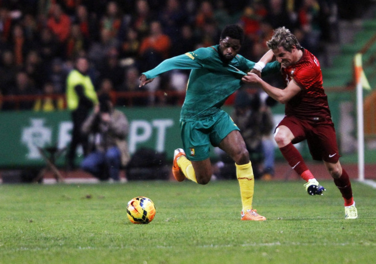 Portugal's Fabio Coentrao (R) fights for the ball with the Cameroon's Alex Song during their international friendly soccer match at Leiria stadium March 5, 2014.