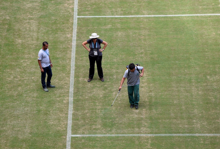 Green paint is sprayed on the parched pitch to improve its colour at Manaus Stadium, ahead of England vs Italy tomorrow