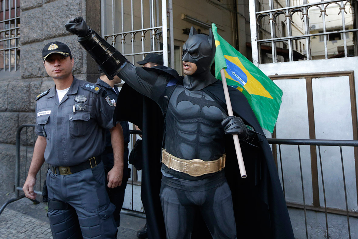 Batman gestures with a national flag at a protest on Brazils Independence Day in Rio, September 7, 2013