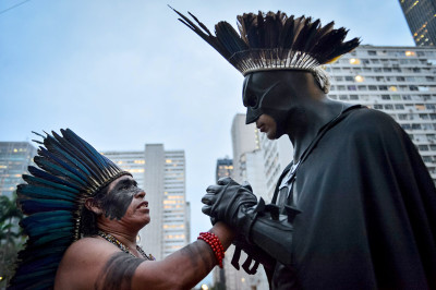 Indigenous leader Korobo speaks with Eron Morais de Melo, aka Batman, during a protest demanding more government support for Brazils indigenous people, on  October 4, 2013