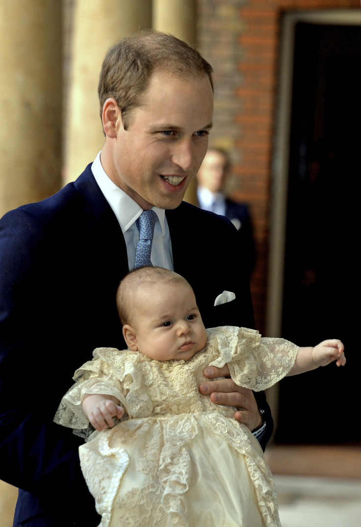 Prince William carries Prince George as they arrive for his son's christening at St James's Palace in London October 23, 2013.