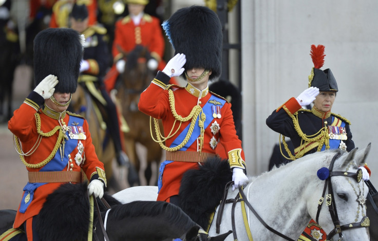 Britain's Prince William, Duke of Cambridge (C), Prince Charles (L) and Princess Anne (R) salute on horseback as they depart Buckingham Palace in the annual Trooping of Colour ceremony