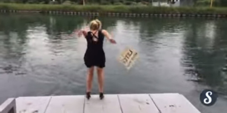 A woman launches herself into the water taking part in l'eau ou l'resto dare. (YouTube)